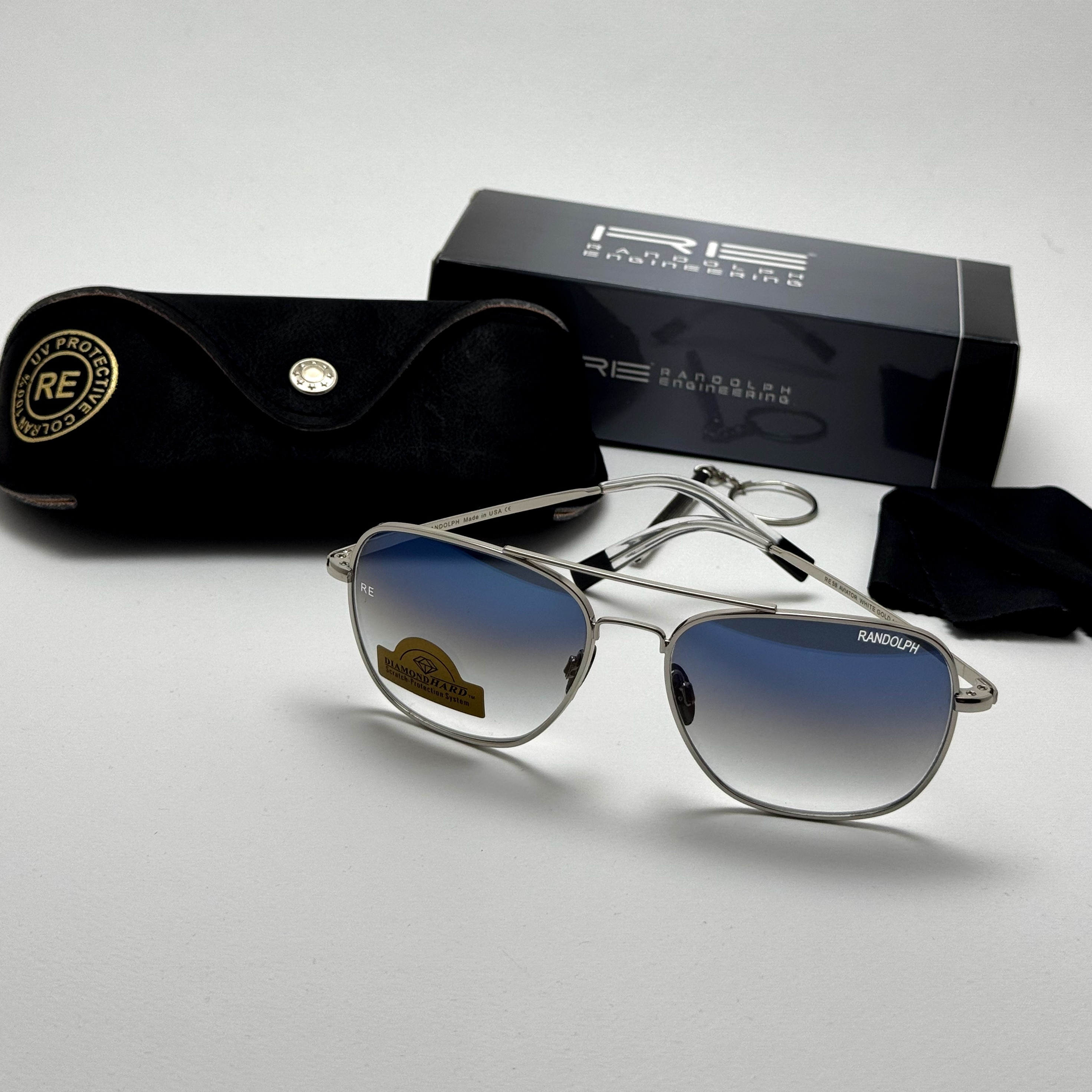 عینک آفتابی خلبانی رندولف شیشه سنگ آنتی رفلکس آبی هایلایت نقره ای فول پک RANDOLPH AVIATOR RE 58 24K WHITE GOLD (ارسال